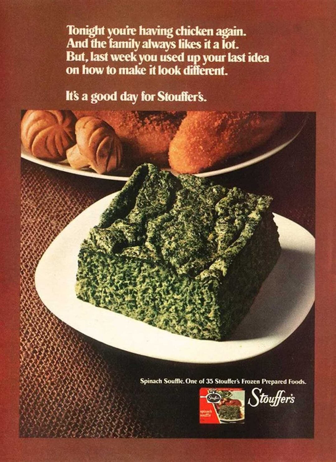 A square slice of spinach soufflé sits on a white plate in the foreground, with bread rolls and fried chicken in the background. White text and the Stouffer’s logo are displayed above and below the image.