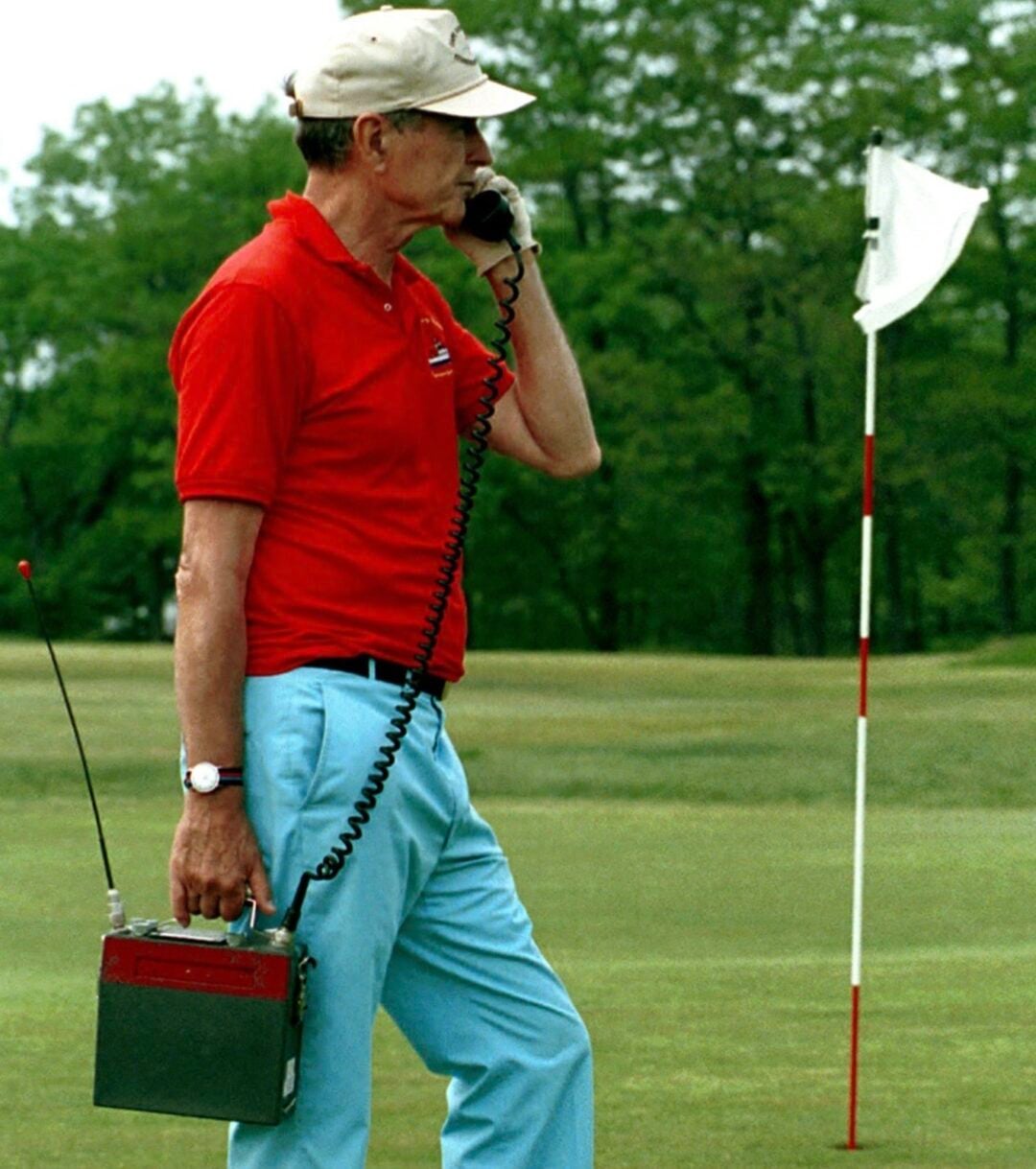 george hw bush on the phone while golfding