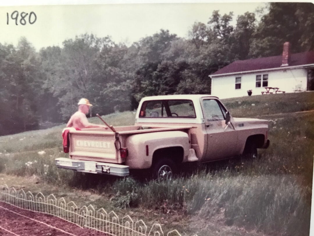 man with a light colored chevy pickup stepside