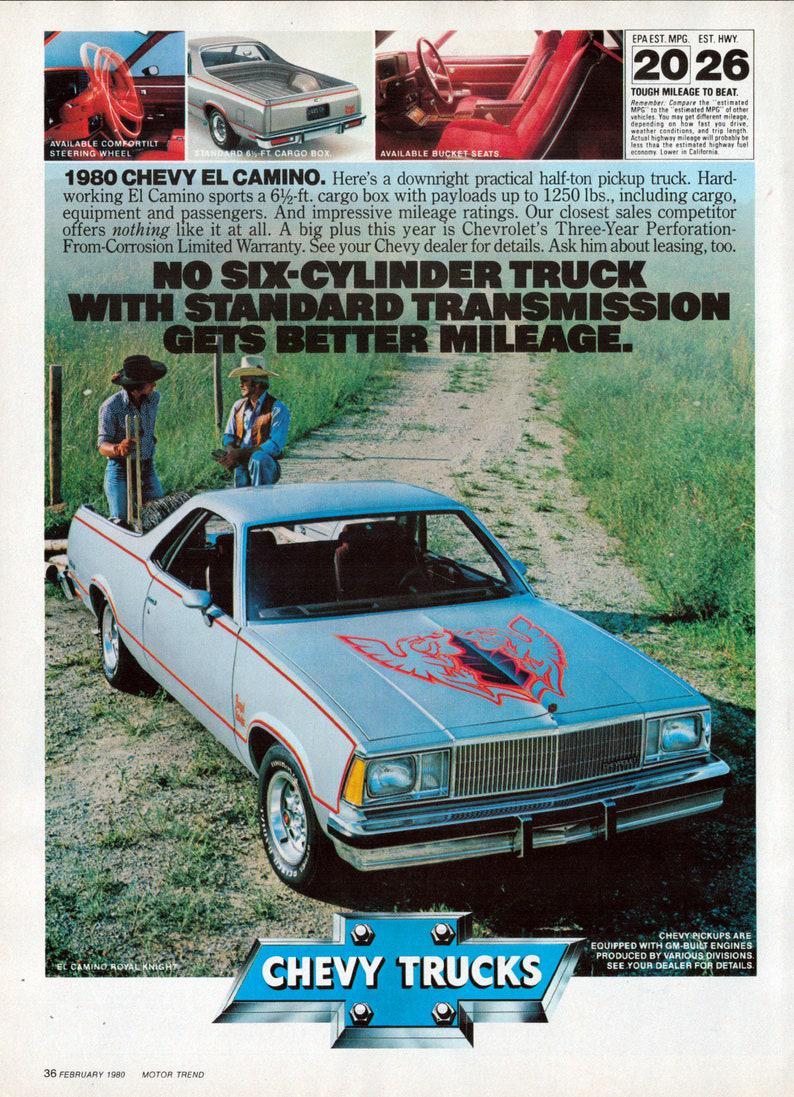 A 1980 Chevy El Camino is parked on grass, featuring a silver body with red and blue decal designs on the hood. A man in a red shirt leans on the truck's side, and a woman stands nearby. Text and small car images appear above.