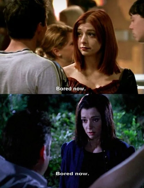 Two scenes from a TV show: In both, a woman with red hair faces a man and says "Bored now." In the second scene, the woman has dark hair and is outdoors at night, repeating the same phrase.