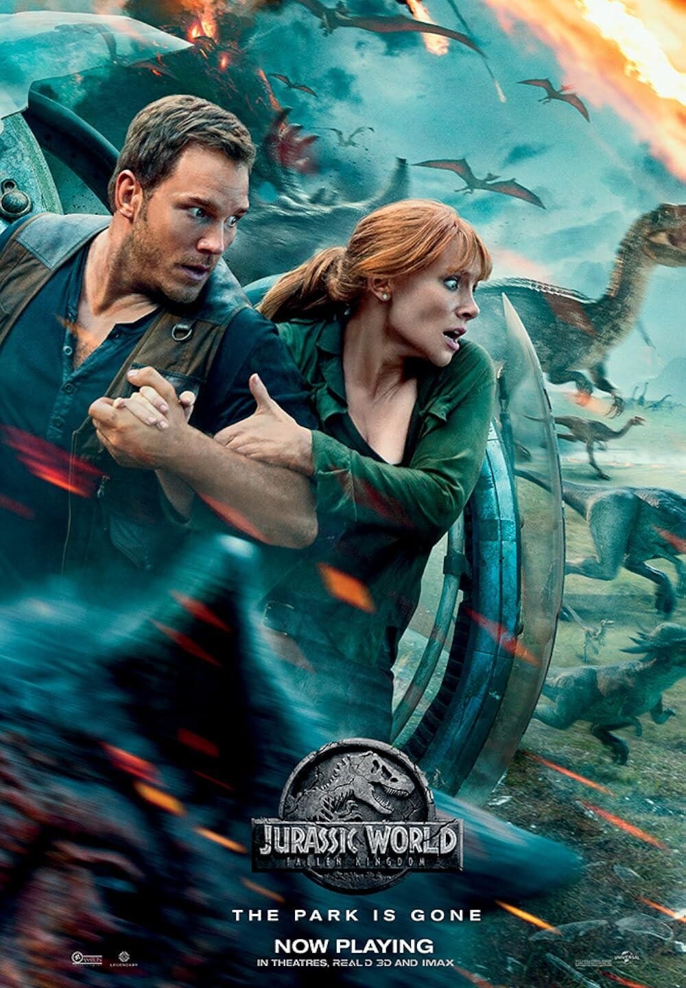 A man and woman run holding hands through chaos as dinosaurs chase them in the background. The scene is tense and dramatic, with explosions and debris. Text at the bottom reads: "Jurassic World: Fallen Kingdom. The Park Is Gone. Now Playing.