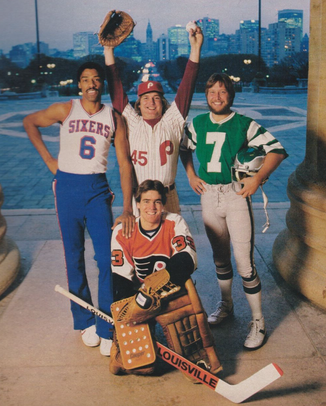 Four men pose outdoors in sports uniforms: a basketball player, a baseball player raising his arms, a hockey goalie kneeling with his stick, and a football player; a city skyline is visible in the background.