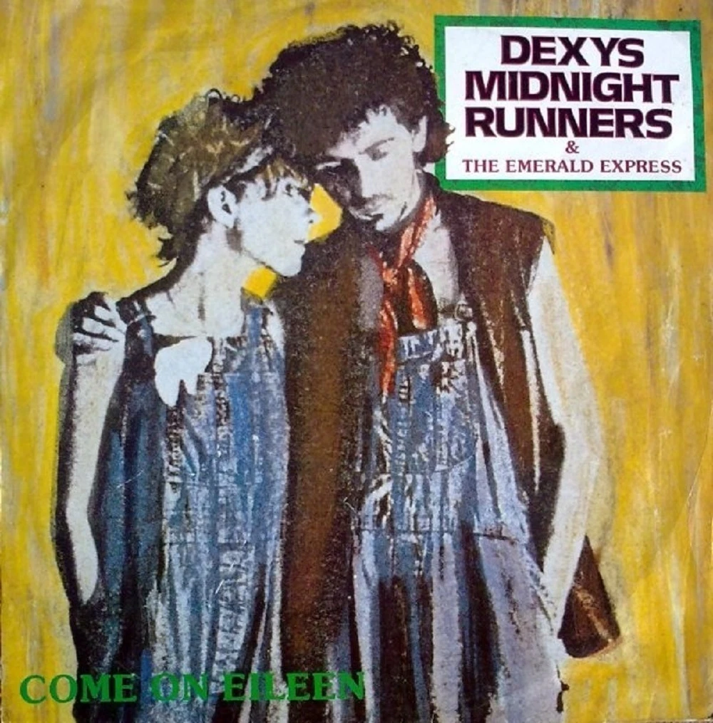 Two people wearing denim overalls stand close together against a yellow background. Text reads "DEXYS MIDNIGHT RUNNERS & THE EMERALD EXPRESS" and "COME ON EILEEN" at the bottom.