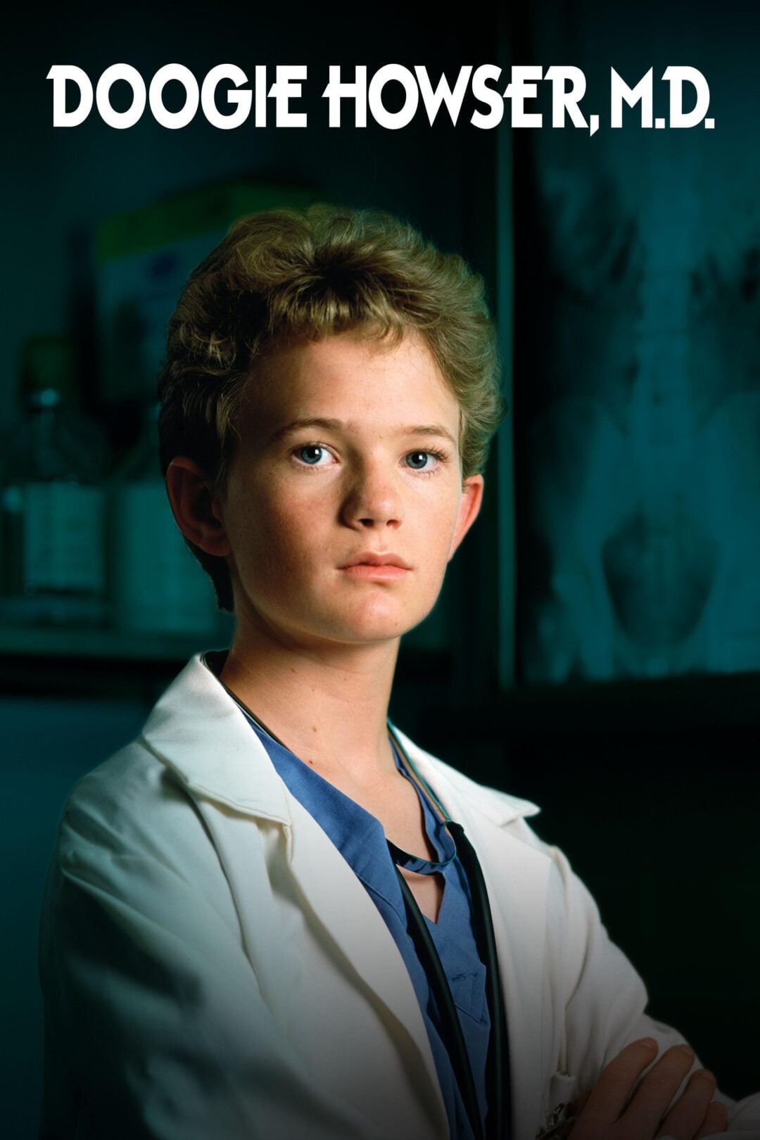 A teenage boy in a white lab coat and blue scrubs stands confidently with "Doogie Howser, M.D." written in bold white letters above him. The background is a dimly lit medical setting.