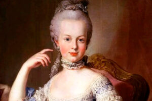 A classical portrait of a woman in 18th-century attire with a tall powdered wig, ornate hairpiece, lace choker, and elegant dress, seated on a decorative chair, posing with one hand near her face.