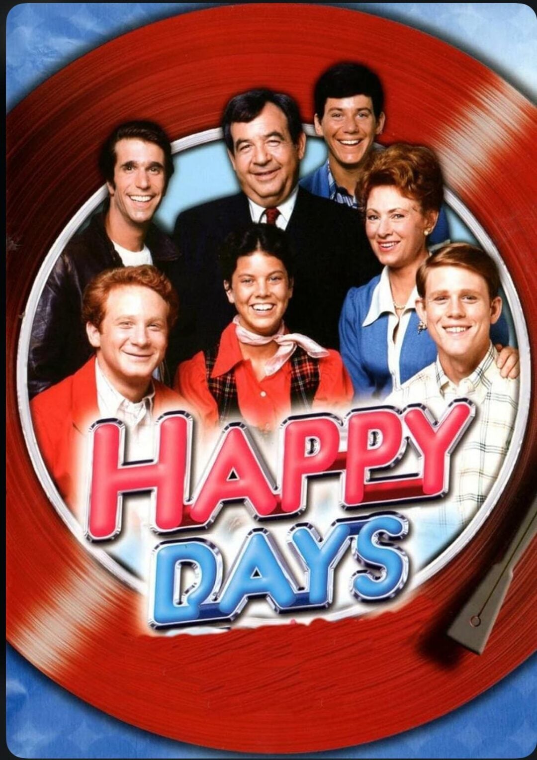 A group of seven smiling people, dressed in retro 1950s-style clothing, pose inside a vinyl record frame with the words "Happy Days" in bold, colorful letters across the bottom.