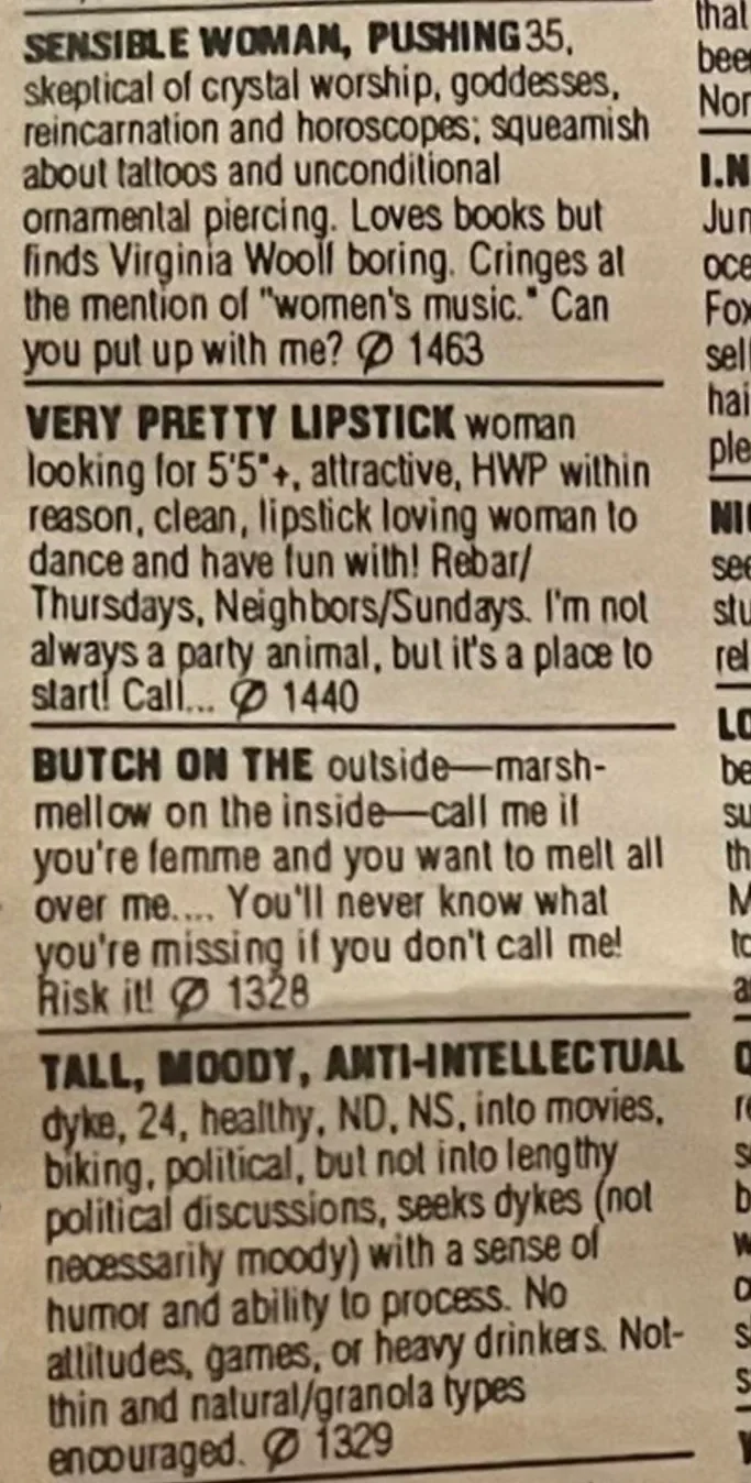 A close-up of a personals section in a newspaper featuring classified ads with bolded titles like "SENSIBLE WOMAN, PUSHING 35," "VERY PRETTY LIPSTICK," "BUTCH ON THE outside," and "TALL, MOODY, ANTI-INTELLECTUAL.