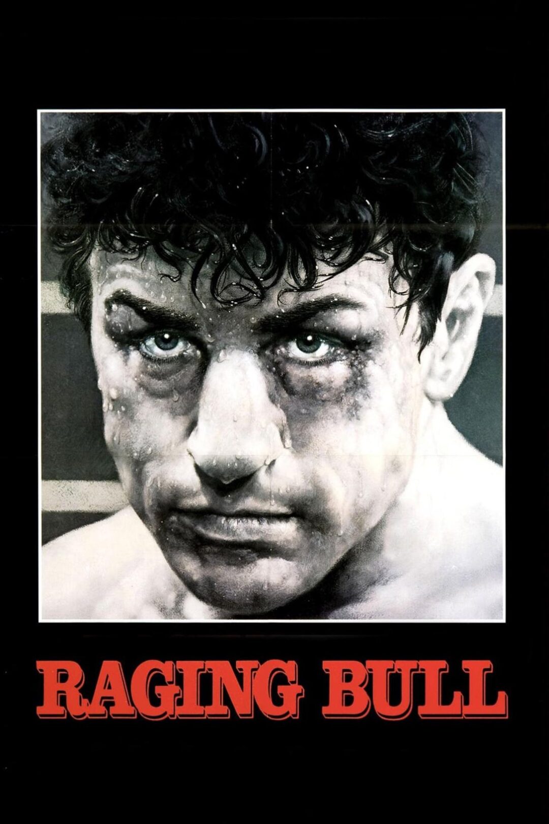 A close-up of a man’s intense, sweaty face with wet hair, water droplets, and a determined expression. Below the image, bold red text reads "RAGING BULL" on a black background.