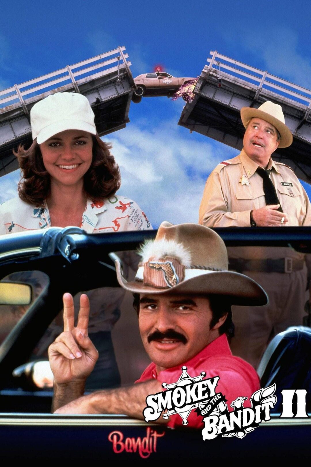 Movie poster for "Smokey and the Bandit II" showing a man in a cowboy hat giving a peace sign, a woman smiling, a sheriff in uniform, and a car jumping over a broken bridge in the background.