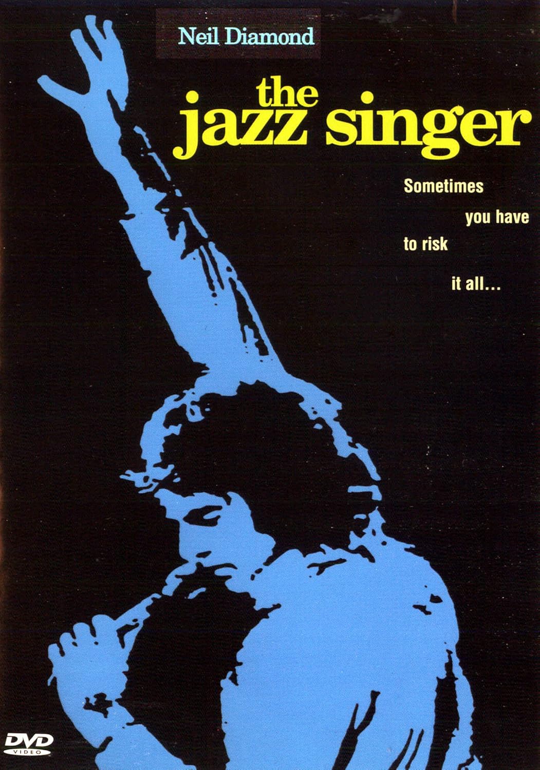 A stylized blue illustration of a man holding a microphone with one arm raised. Text reads: "Neil Diamond, the jazz singer. Sometimes you have to risk it all..." and there is a DVD logo in the bottom left corner.