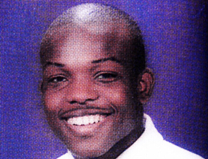 A young man with a shaved head smiles at the camera, wearing a white shirt and black tie, in front of a blue background. The words "Poppel eBay" are overlaid on the image.
