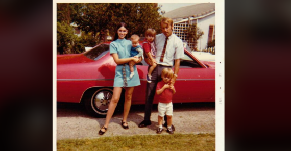 A family of five poses in front of a red car. Two adults stand with three young children on a suburban street, with trees and houses in the background. The photo appears to be from the 1970s.