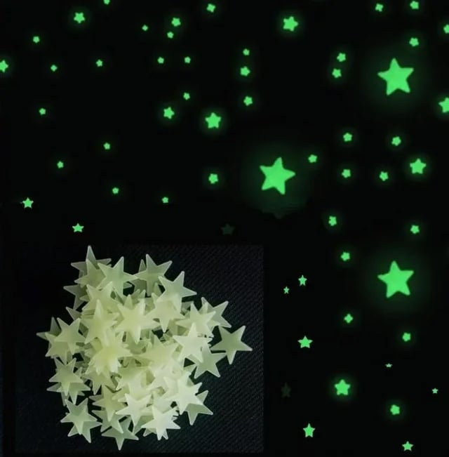 A pile of plastic glow-in-the-dark star stickers is shown on a dark surface. Above, the same stars are glowing green and scattered across a black background, resembling stars in the night sky.