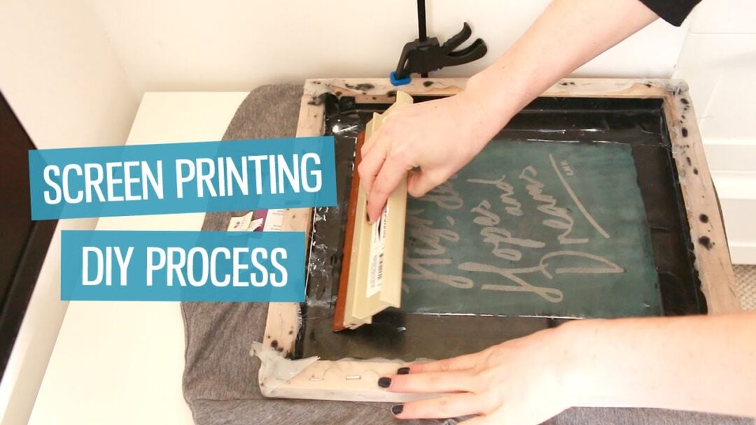 A person uses a squeegee to press ink through a screen onto a T-shirt as part of a screen printing DIY process. Text on the image reads "SCREEN PRINTING" and "DIY PROCESS.