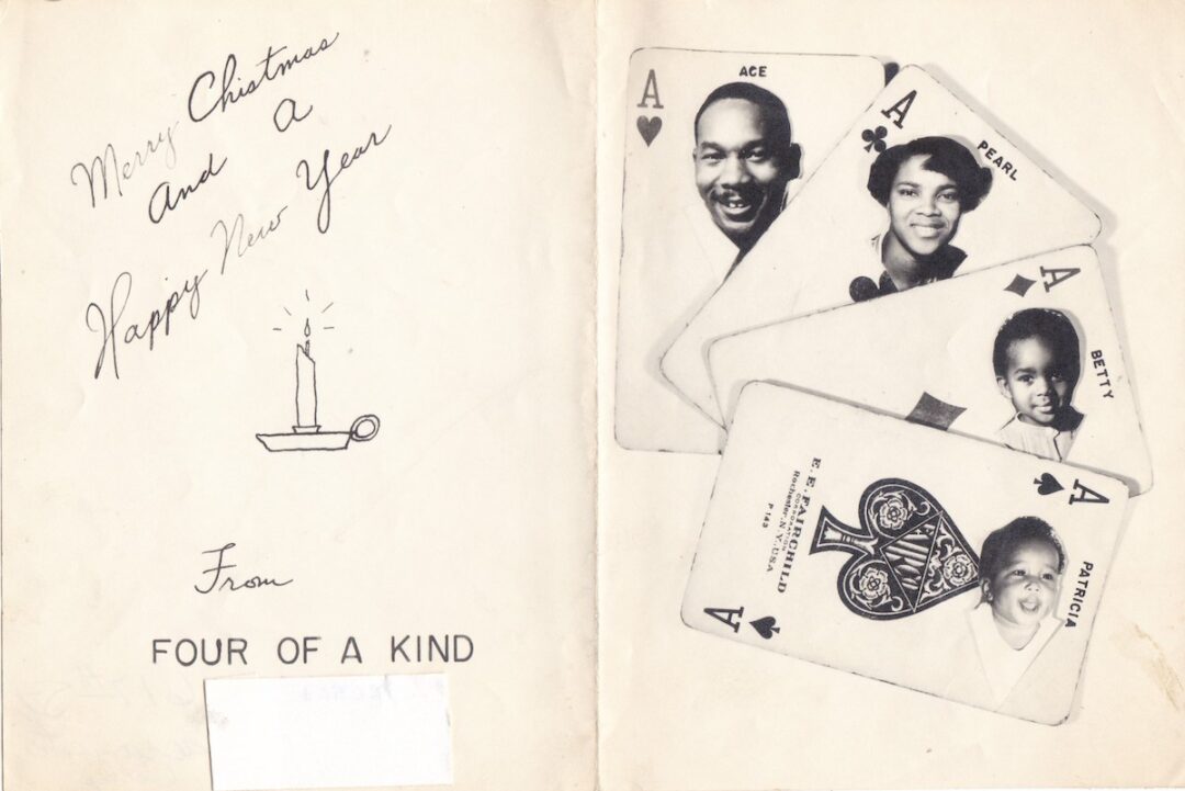 A holiday card reads “Merry Christmas and a Happy New Year from Four of a Kind,” with a candle drawing. Next to it are four playing cards, each with a family member’s portrait and name on a different ace.