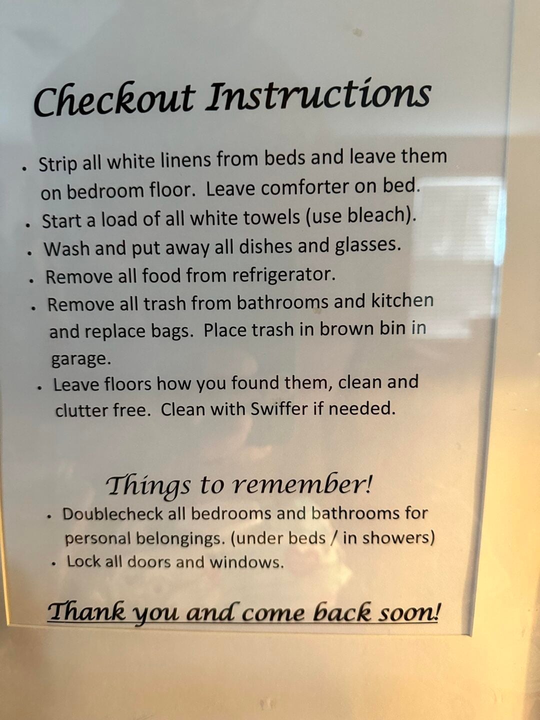A printed sign titled "Checkout Instructions" lists tasks for guests, including stripping linens, starting laundry, washing dishes, removing food and trash, sweeping floors, and securing personal belongings and doors.