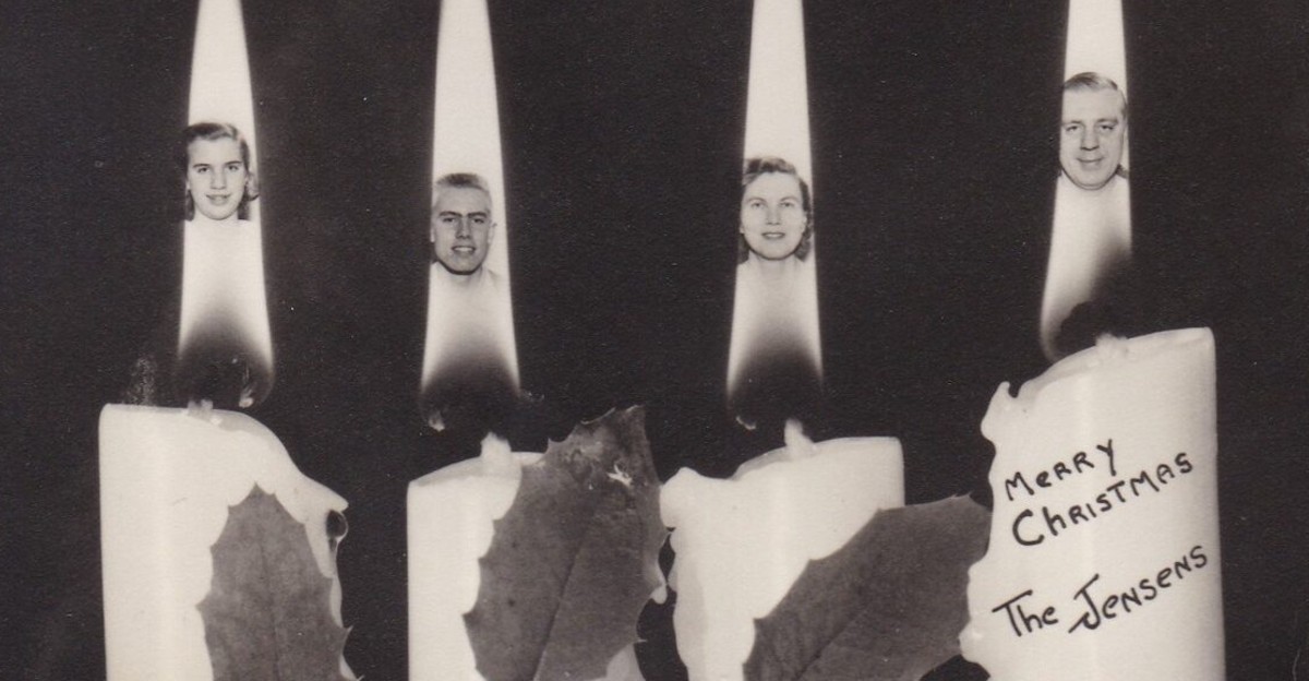 Four candles with flames replaced by faces of two men and two women. The candles are decorated with holly, and a note reads "Merry Christmas The Jensens" on the rightmost candle. The background is dark.