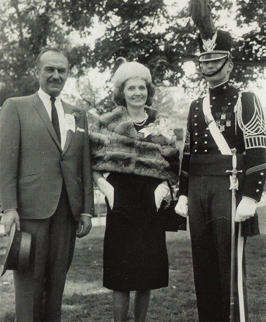 A man and woman standing next to a man in military uniform
