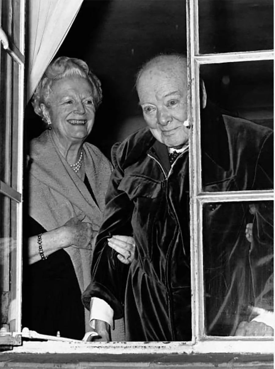 A couple of women looking out a window