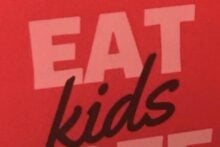 A red sign with bold white text that says "EAT FREE" and the word "kids" in black, suggesting "KIDS EAT FREE," but the layout humorously reads as "EAT KIDS FREE.