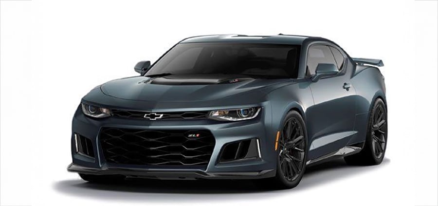A dark gray Chevrolet Camaro sports car viewed from the front left angle, showcasing its aggressive grille, sharp headlights, and aerodynamic design against a white background.