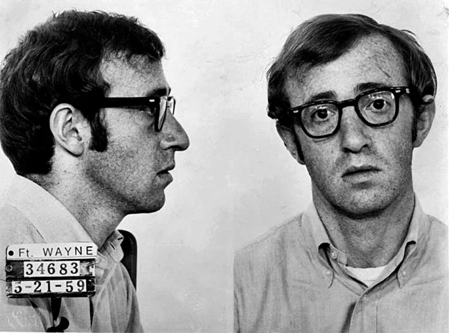 A black-and-white mugshot photo showing a man with glasses in both side and front views. He has short hair and wears a collared shirt. The placard reads "Ft. Wayne 34683 5-21-59.
