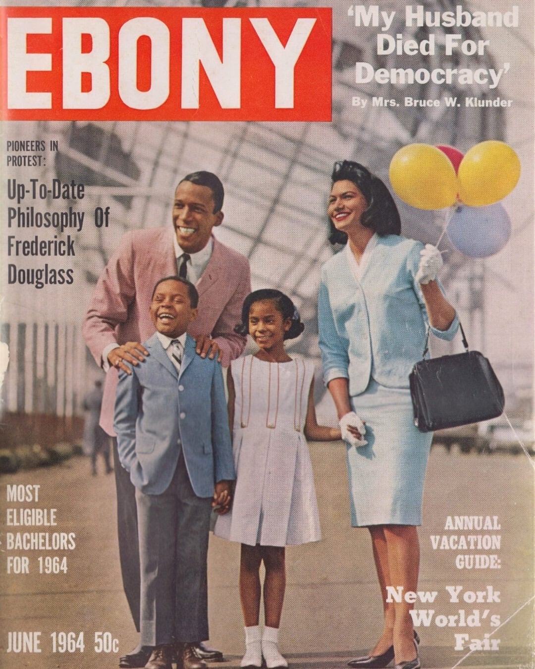 A smiling Black family of four dressed in stylish 1960s attire stands together. The mother holds colorful balloons, and the New York World's Fair grounds are visible in the background. "EBONY" magazine, June 1964, is the cover.