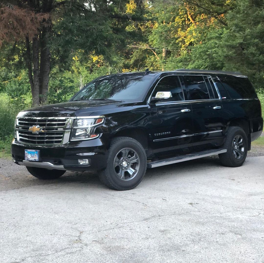 A black suv parked in a driveway