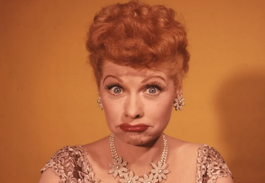 A woman with red hair and a necklace