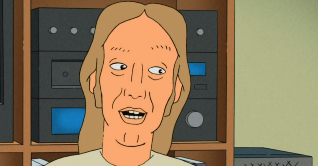 An animated character with long light brown hair and a tan complexion is speaking, shown in front of shelves with black and blue audio equipment. The background is simple, with muted colors.