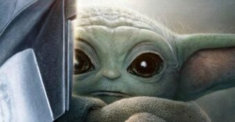 A close-up of the Mandalorian in shiny armor and Grogu (Baby Yoda) looking toward the viewer. Text reads: "The Mandalorian and Grogu. May 21. Only in theaters.