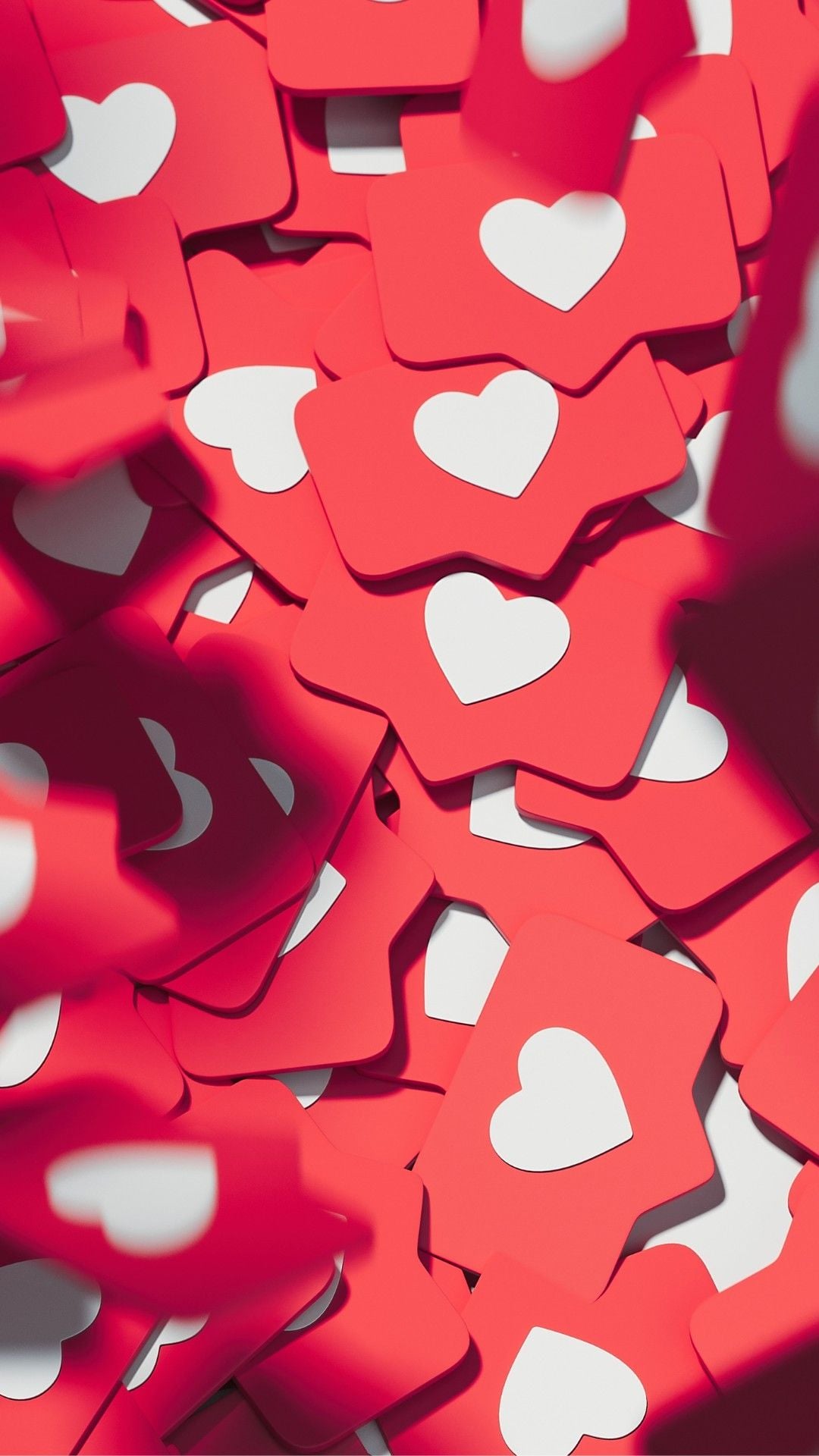 A pile of red cards, each with a white heart symbol in the center, resembling social media like notifications.