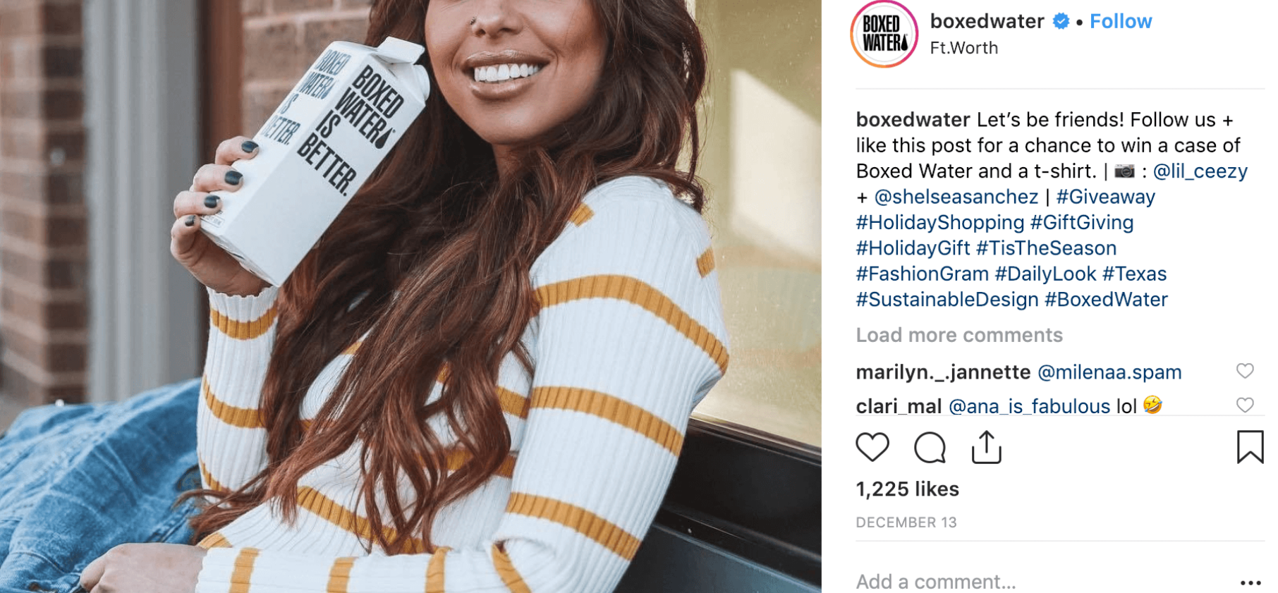 A smiling woman with long brown hair sits outside wearing a white sweater with yellow stripes, holding a Boxed Water carton next to her face.