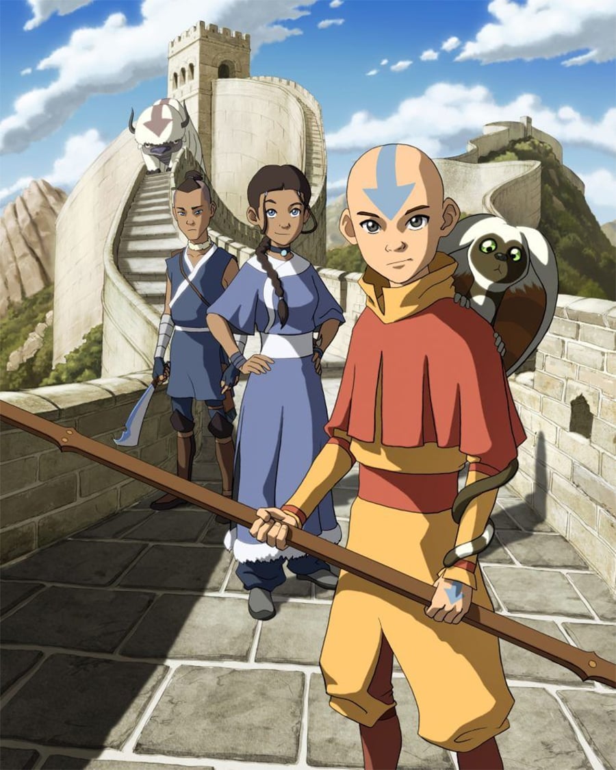 Three animated characters from "Avatar: The Last Airbender" stand on a stone wall with mountains behind them. Aang holds a staff, Katara and Sokka stand nearby, and a small flying lemur perches on Aang’s shoulder.