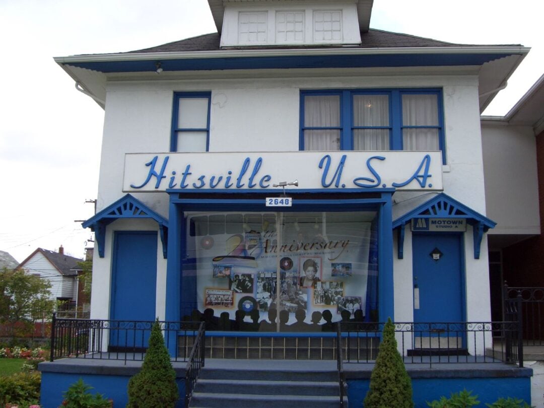 A white and blue two-story building with "Hitsville U.S.A." written above the entrance. The front window displays Motown memorabilia. The address "2648" is above the door.
