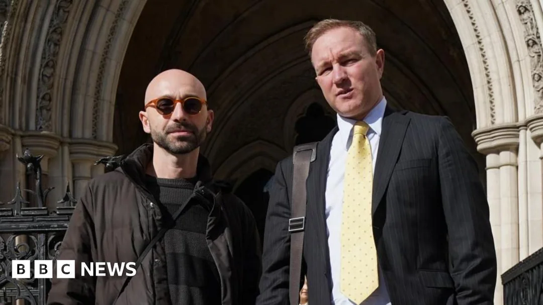 Two men stand outside a building with ornate arches; one wears sunglasses and a dark jacket, the other wears a suit and yellow tie, carrying a bag. The BBC News logo appears at the bottom left.