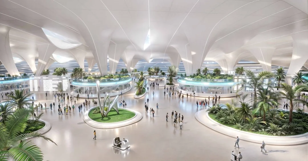 Spacious, modern airport interior with high white ceilings, large windows, lush greenery, digital displays, and groups of people walking or standing throughout the open, bright terminal.