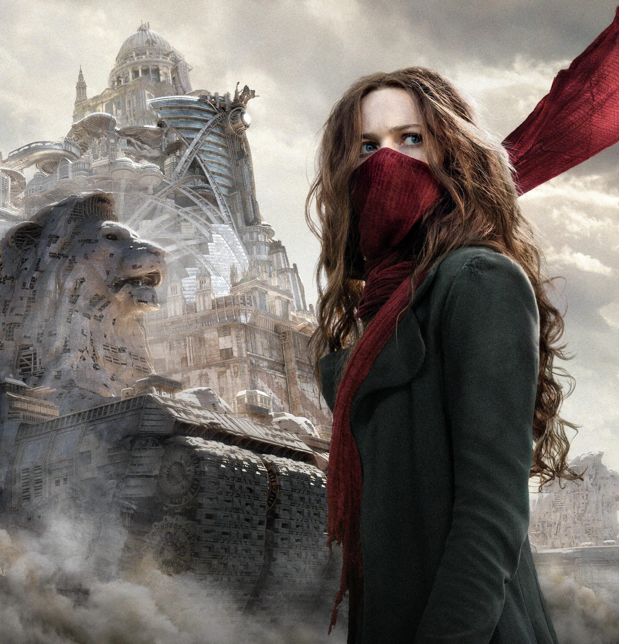 A woman with long brown hair, wearing a green coat and a red scarf covering her mouth, stands in front of a massive, mechanical city structure with lion statues and domed buildings amid swirling dust and clouds.