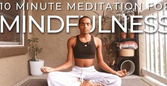 Person sitting cross-legged on a patio, eyes closed, meditating. Text above reads, "10 Minute Meditation for Mindfulness." Plants and cushions are in the background.