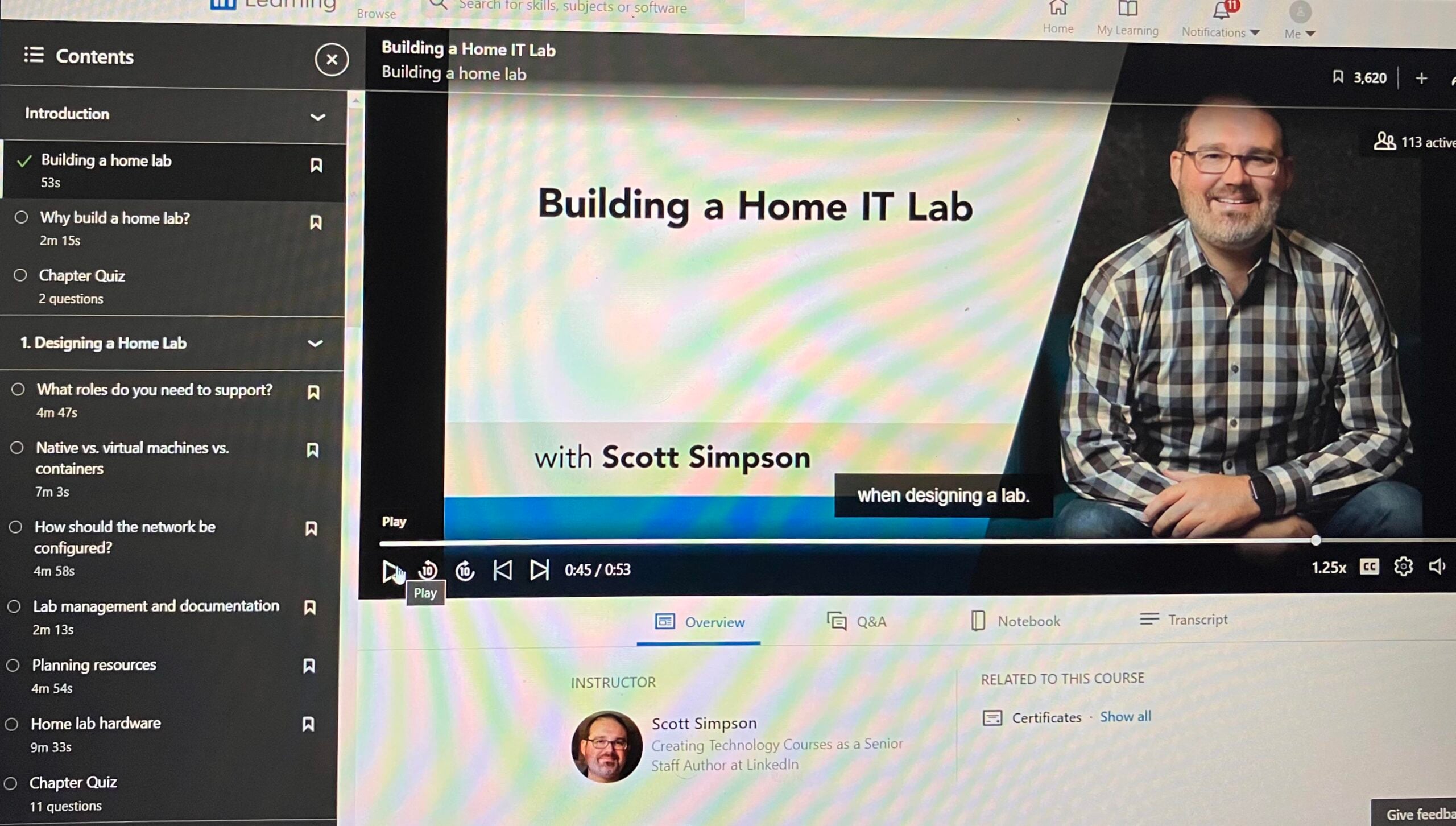 Screenshot of an online course titled "Building a Home IT Lab" featuring instructor Scott Simpson. The video player shows Scott smiling, with course navigation and video transcript visible on the left side of the screen.