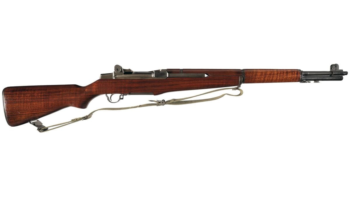 A vintage semi-automatic rifle with a wooden stock and metal barrel, equipped with a canvas sling. The rifle is photographed side-on against a white background.