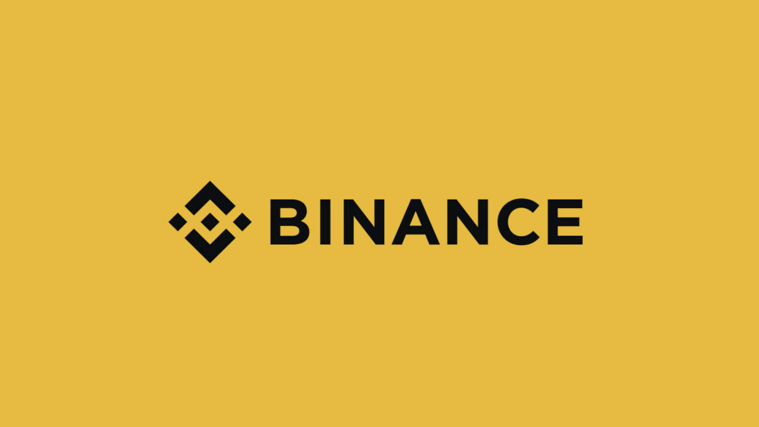 The Binance logo featuring a black geometric symbol next to the word "BINANCE" in bold black letters on a solid yellow background.