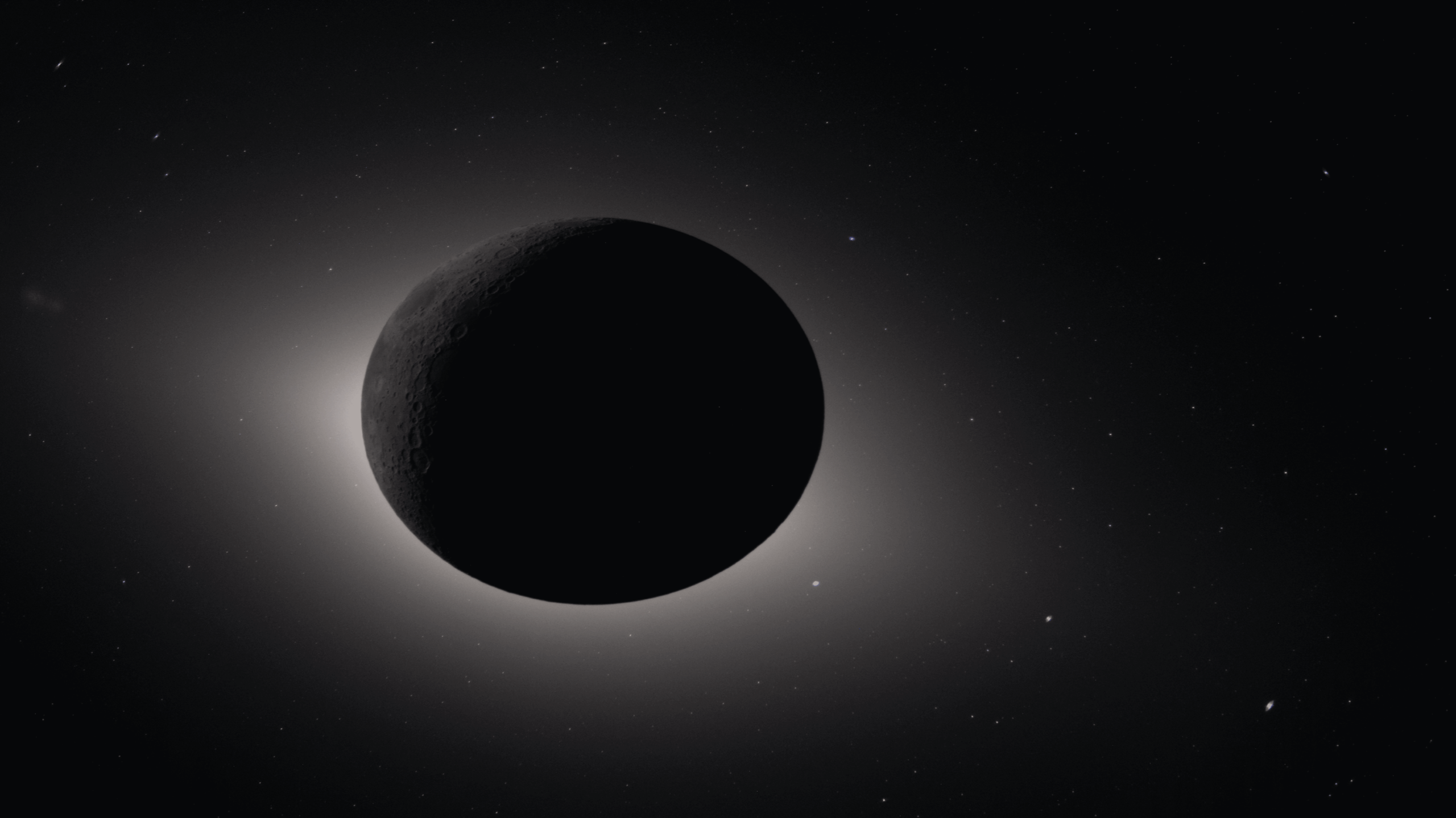 A dark planet or moon is silhouetted against a glowing light source, with a subtle halo effect around it and faint stars scattered in the background.