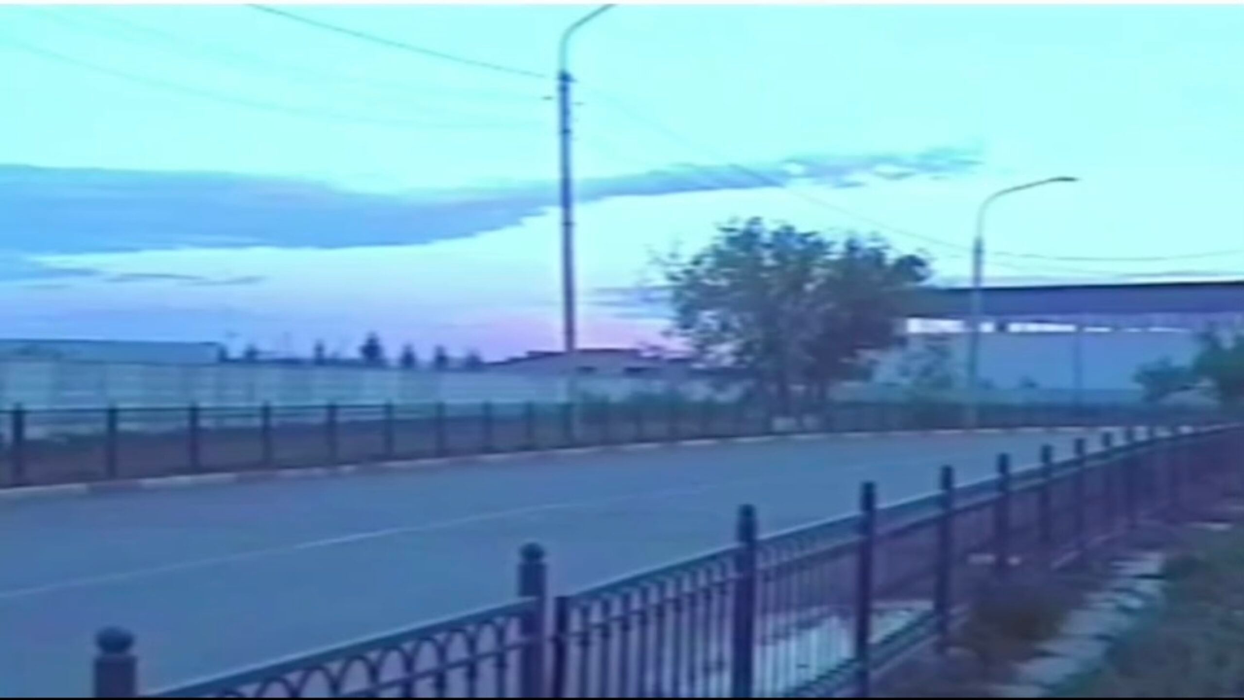 Images of an empty highway at dawn with soft blue tones and no traffic