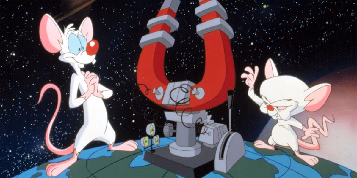 Two animated lab mice stand on a globe in space. One mouse is tall and enthusiastic, the other is short and serious, operating a large red horseshoe magnet machine with wires and gauges. Stars fill the background.