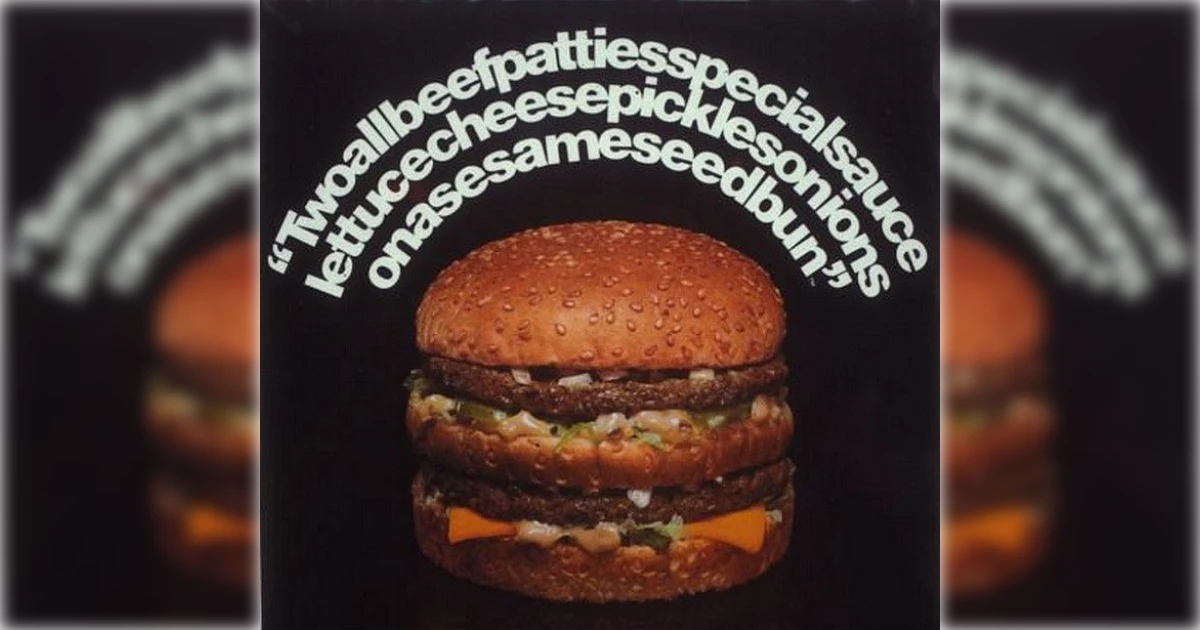 A sesame seed bun hamburger with two beef patties, lettuce, cheese, pickles, onions, and special sauce. Curved white text above describes the ingredients in a continuous phrase. Black background.