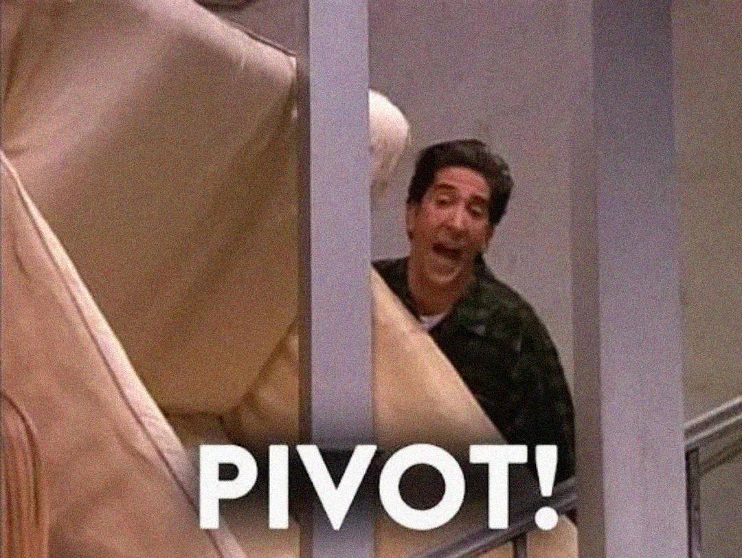 A man tries to move a large beige couch up a staircase, yelling "PIVOT!" in bold white letters.