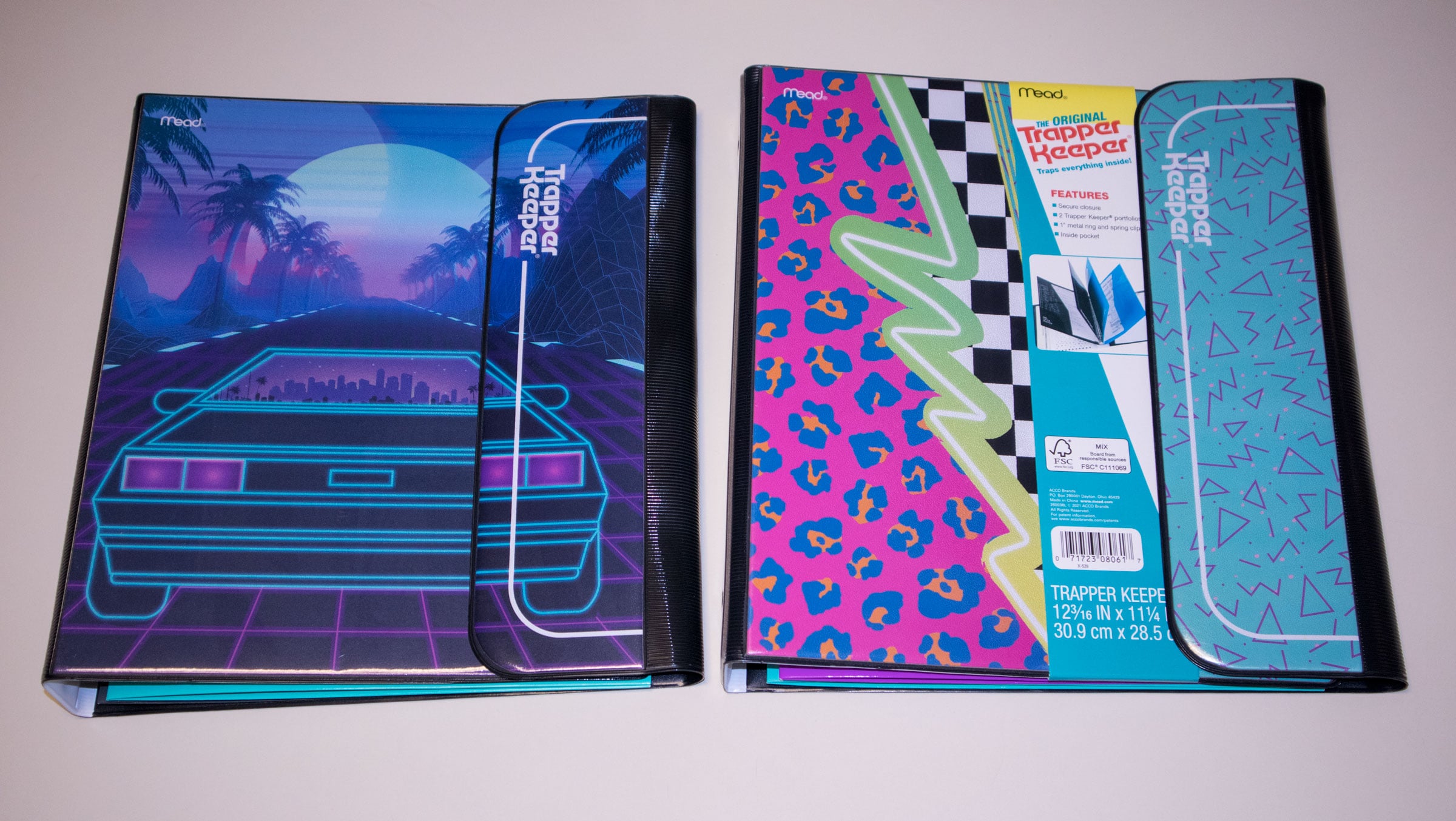 Two Trapper Keeper binders sit side by side. One features a retro car driving into a neon sunset with palm trees, while the other has a teal geometric pattern and a pink, blue, and green animal print design.