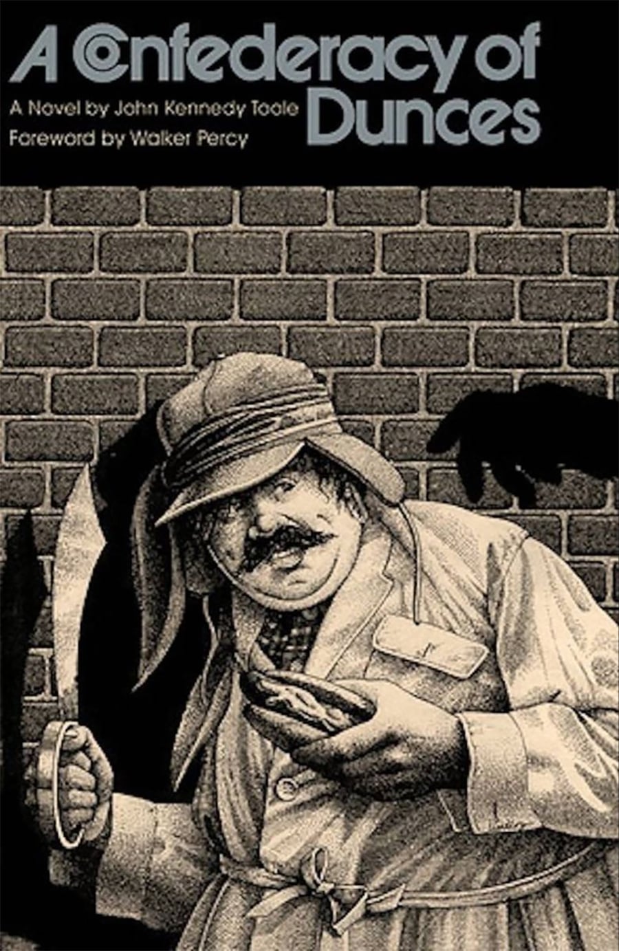 Book cover of "A Confederacy of Dunces" depicting a man in an old-fashioned coat and hat, holding a hot dog, standing against a brick wall. Title and author appear at the top in bold, stylized letters.